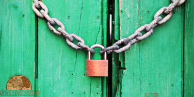 A lock on a wooden door. | Creating An Asset Protection Plan