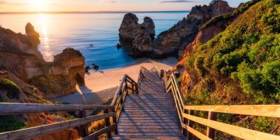 Wooden footbridge to the beach Praia do Camilo, Portugal.