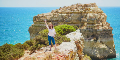 Tourist enjoying scenic landscape in Algarve, Portugal