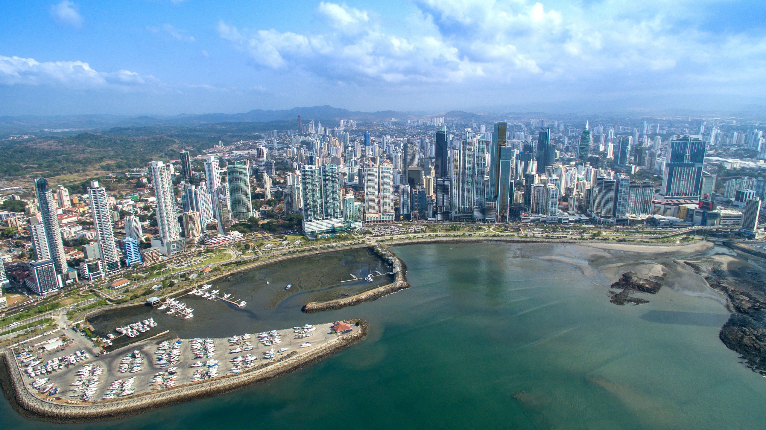 Panama Bahia Ariel View of Panama City And The Bay With Impressive High Rise Buildings In The Foreground And Mountains In The Distance