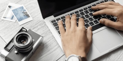 Person at a laptop with camera next to him