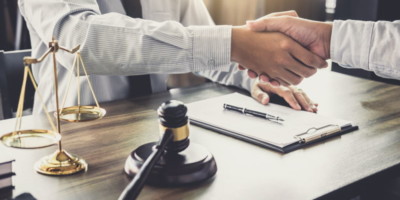 A lawyer shaking hands with a client