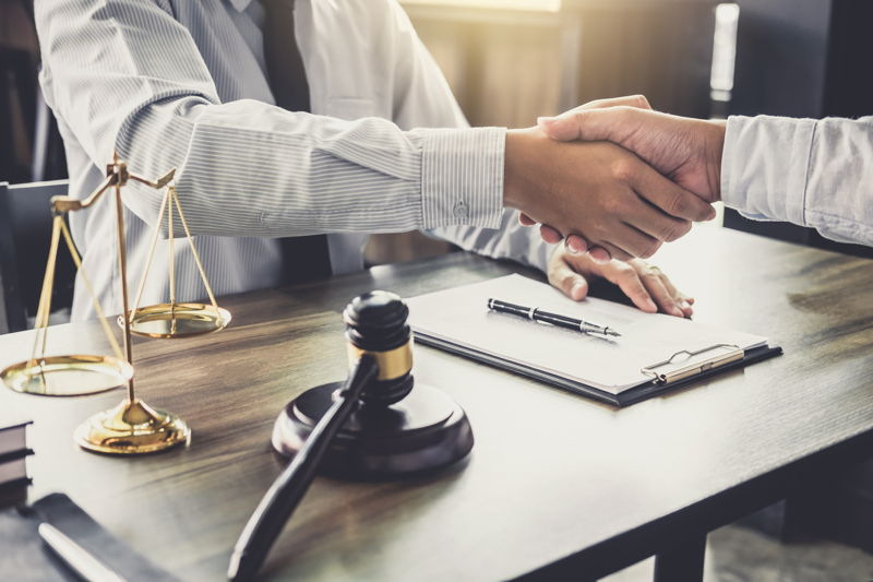 A lawyer shaking hands with a client