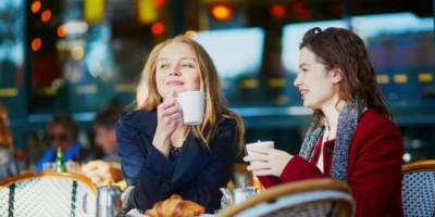 Friends speaking french at a cafe