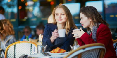 friends in paris cafe having coffe and talking