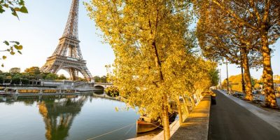 Landsacpe view of Eiffel tower during the sunrise with beautiful yellow trees in autumn in Paris