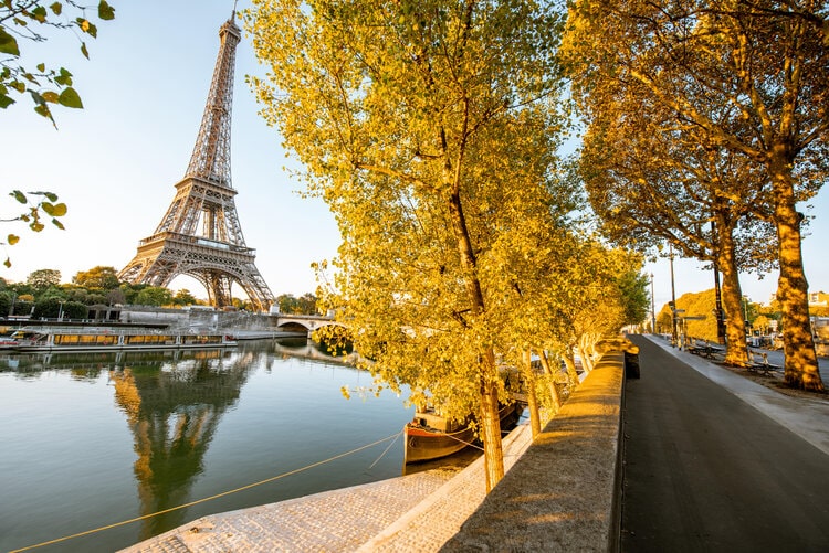 Landsacpe view of Eiffel tower during the sunrise with beautiful yellow trees in autumn in Paris