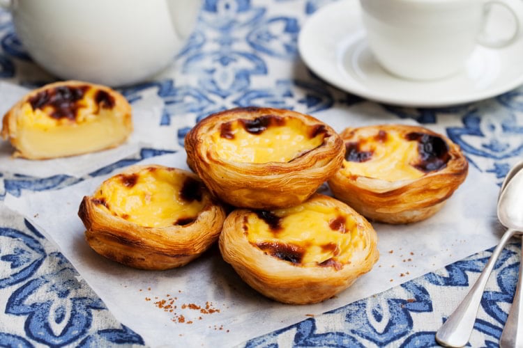 Egg tart, traditional Portuguese dessert, pastel de nata on a parchment paper