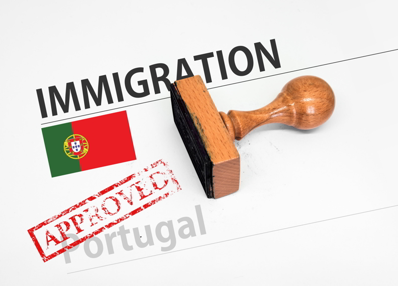 Approved Immigration Portugal application form with rubber stamp.