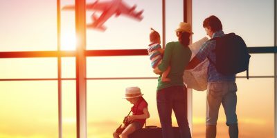 Happy family with suitcases in the airport.