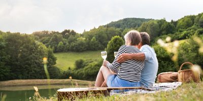 Senior couple at the lake having a picnic.