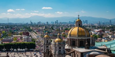 Mexico City, Mexico, Basilica of Our Lady of Guadalupe with Mexico City skyline in the background.