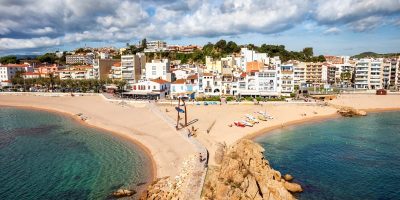 Beach and townscape of Blanes, coastal resort town on Costa Brava in Catalonia, Spain.