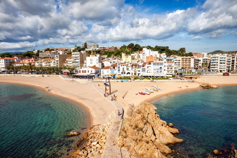 Beach and townscape of Blanes, coastal resort town on Costa Brava in Catalonia, Spain.