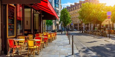 Cozy street with tables of cafe in Paris, France