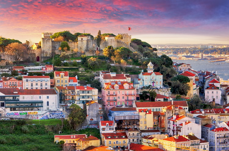 Lisbon, Portugal skyline with Sao Jorge Castle at dawn