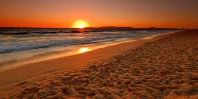 A white sand beach in Comporta, Portugal during sunset