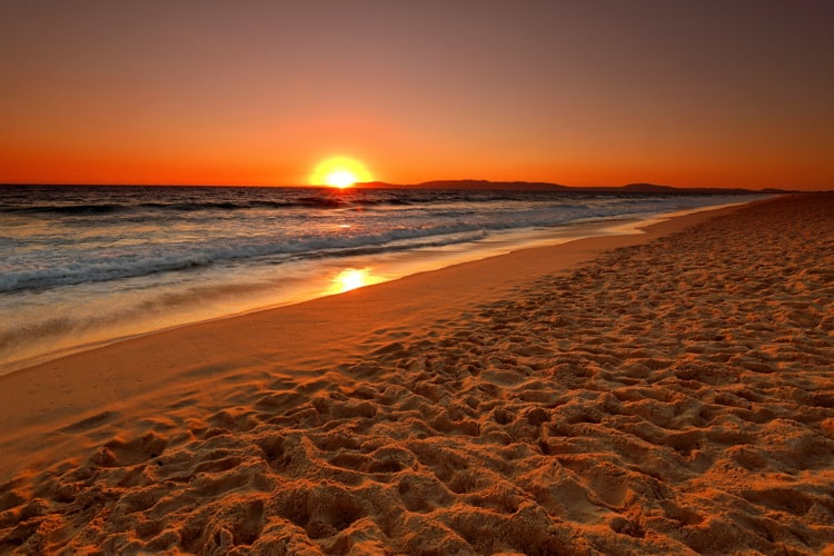 A white sand beach in Comporta, Portugal during sunset