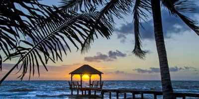 Sunrise on the end of a pier in Placencia, Belize.