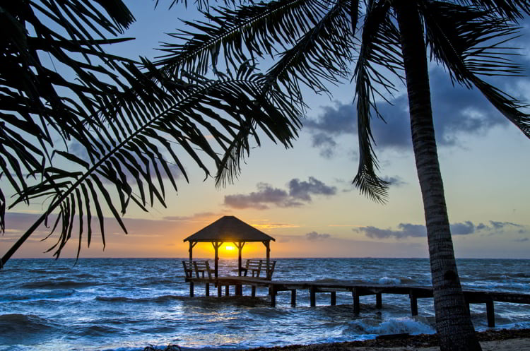 Sunrise on the end of a pier in Placencia, Belize.