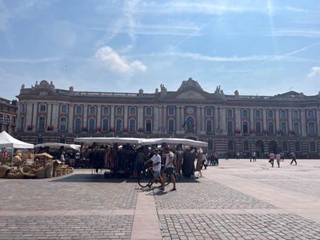 Toulouse’s biggest plaza, Place du Capitole, with a few market stalls set up on each side