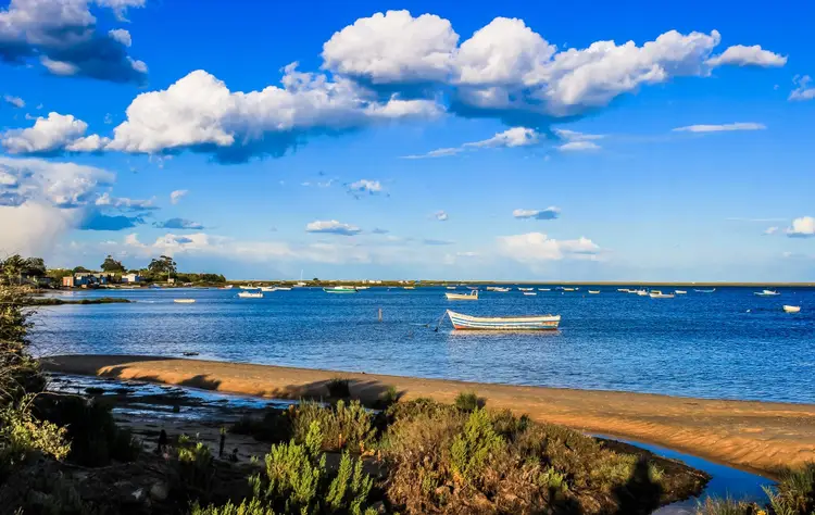 Blue skies, boat on the ocean.